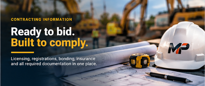 Rolled plan sets, a hard hat and a tape measure on a work truck tailgate